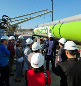A truck driver talking to a group of people about his job transporting ethanol