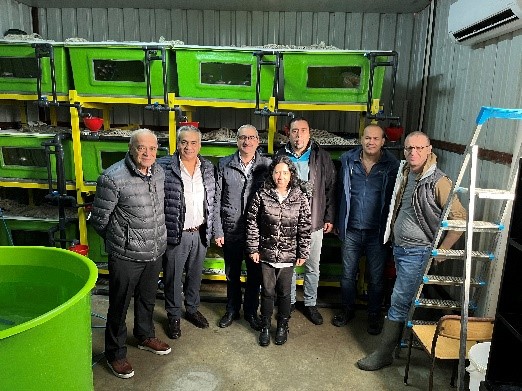 A group of people standing in a university research facility