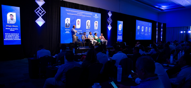 image of people on a panel at a conference