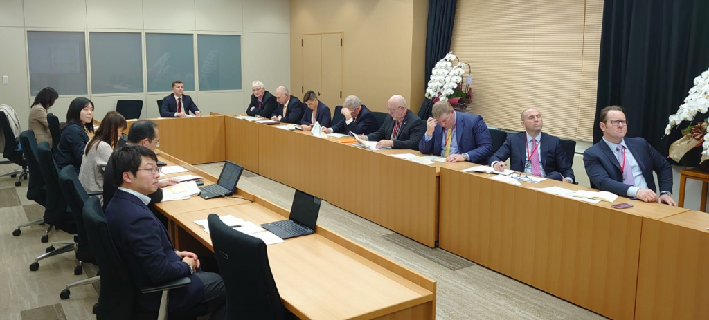 image of people sitting around a table in a meeting room