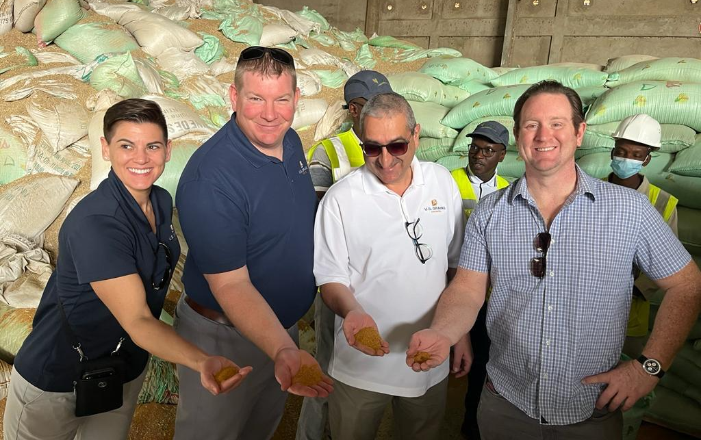 image of four people holding DDGS