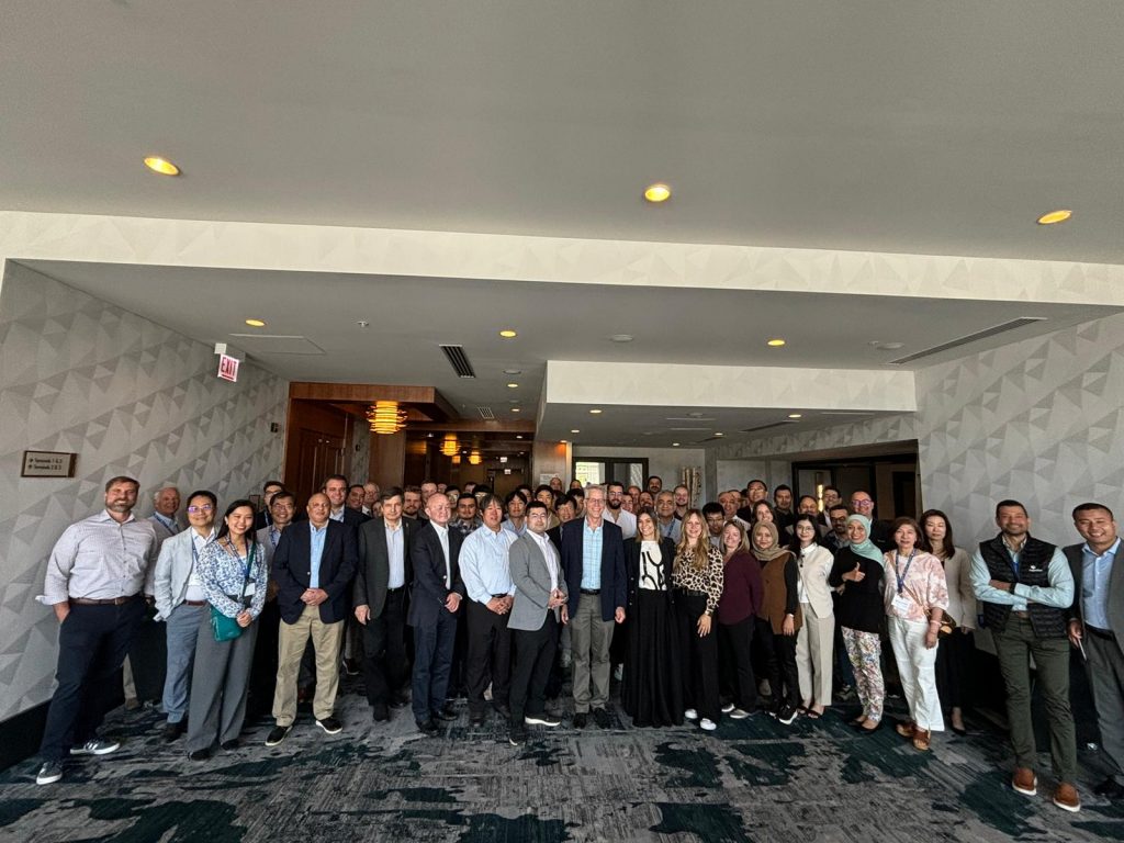A large group of people posing for a photo in a conference room