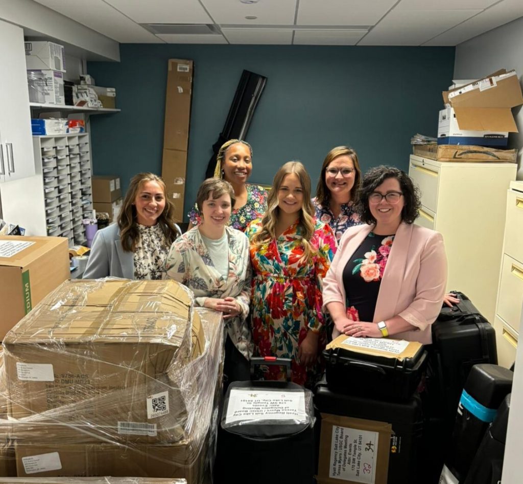 A group of women standing in a storage room