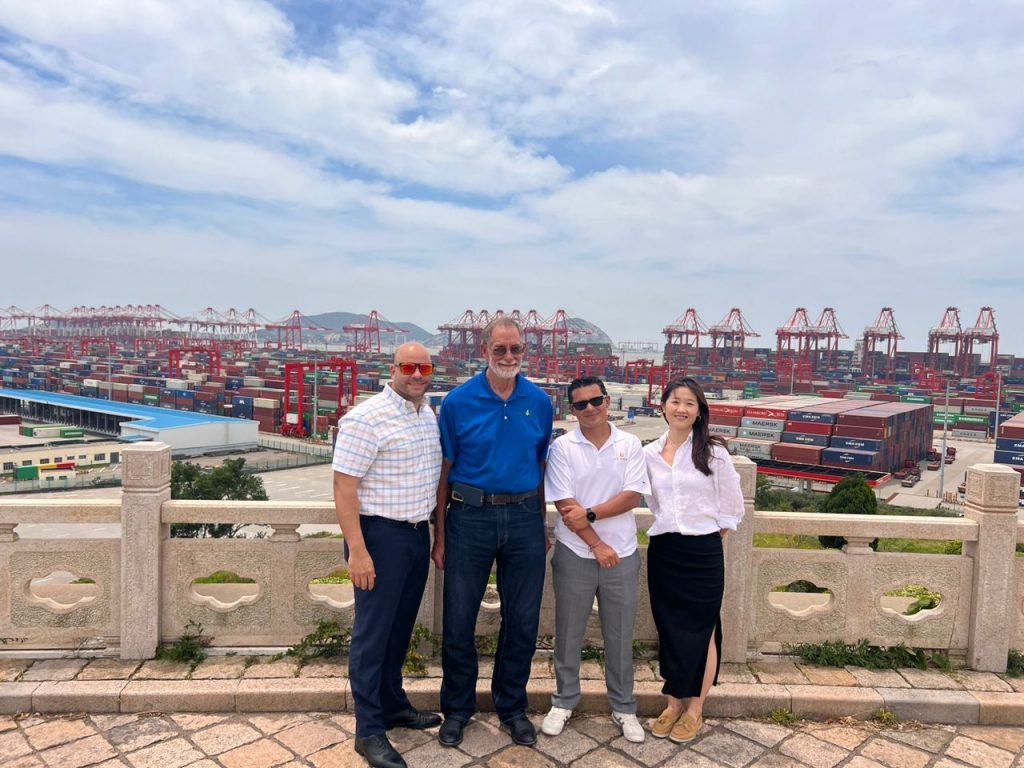 A group of people standing in front of a large port