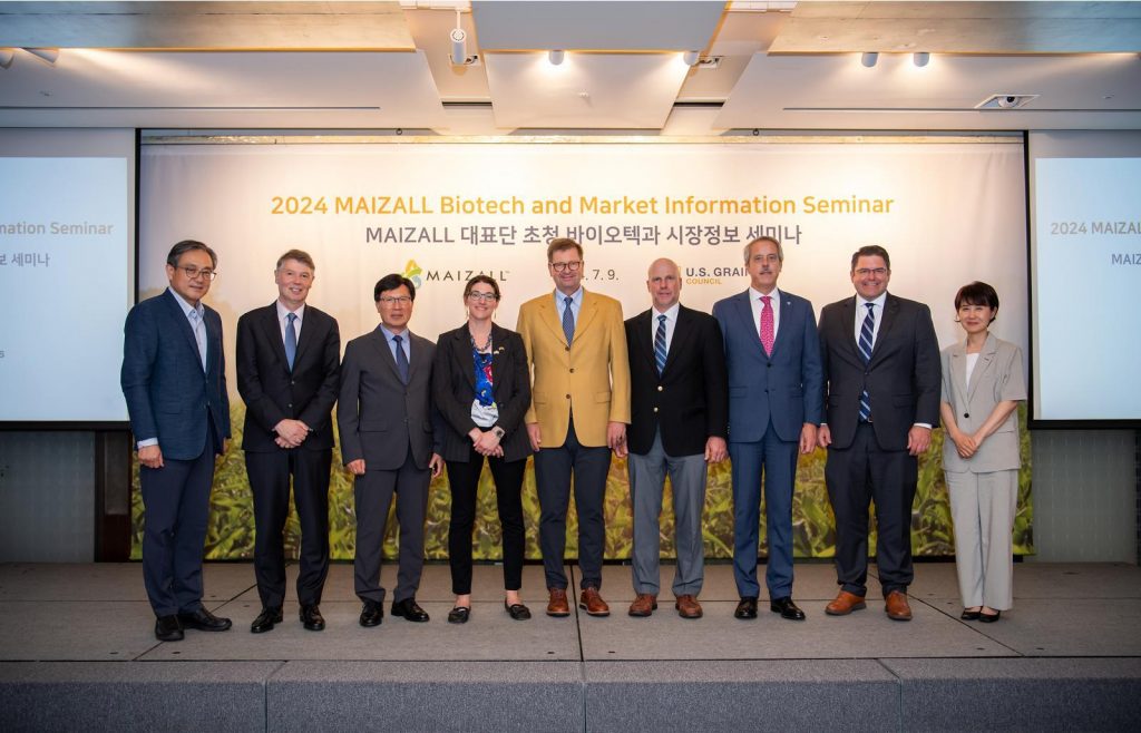 A group of people posing on a conference stage