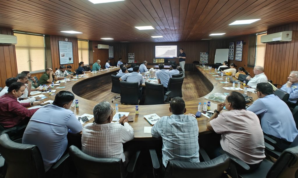 A conference room of people listening to a presentation