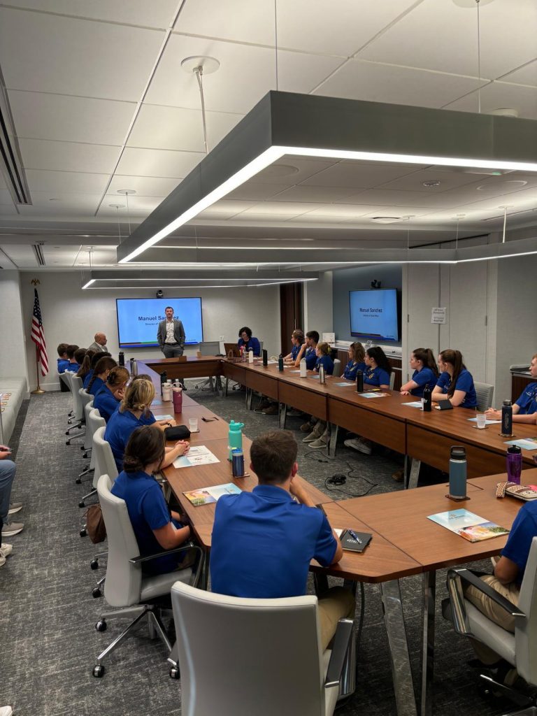 A conference room with students listening to a presentation